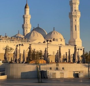 The iconic white domes and minarets of Masjid Quba in Medina, a key visit for those on 3 star Umrah packages in 2026.